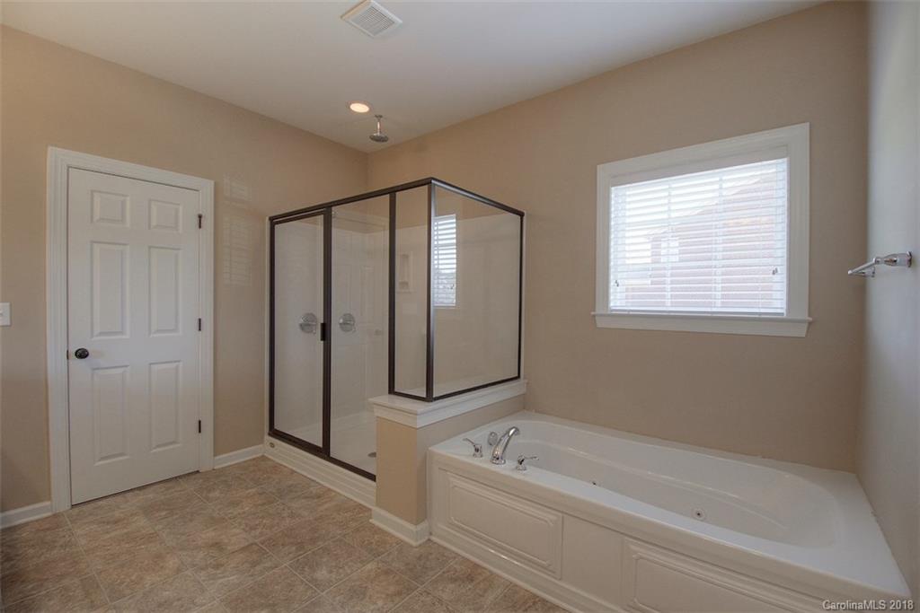 2001 Spring Rose Lane Wesley Chapel, NC 28104 - Photo 30 of 36 a spacious bathroom with a bathtub and a shower