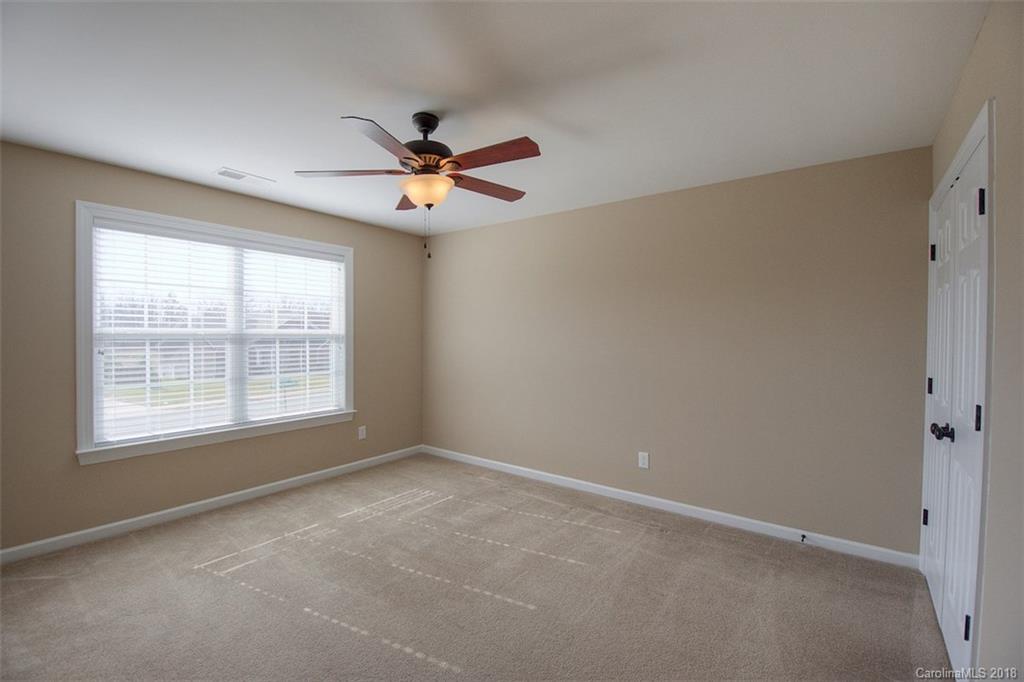 2001 Spring Rose Lane Wesley Chapel, NC 28104 - Photo 34 of 36 an empty room with a window and a fan