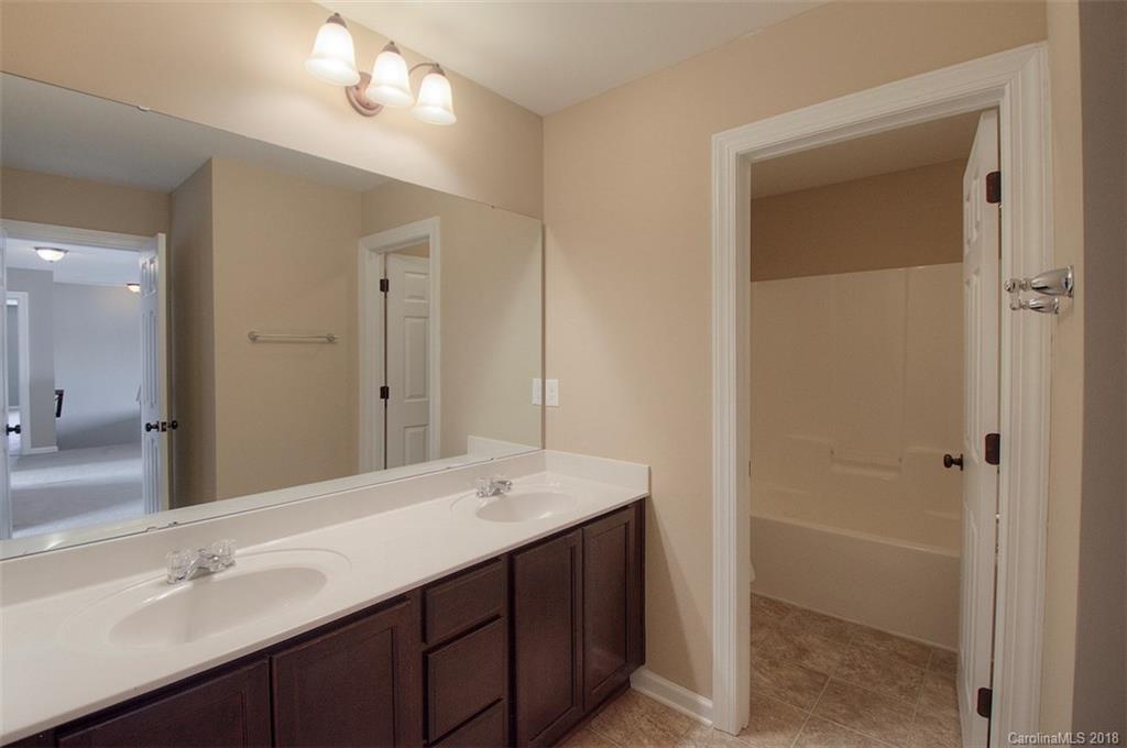 2001 Spring Rose Lane Wesley Chapel, NC 28104 - Photo 35 of 36 a bathroom with 2 sink and a mirror