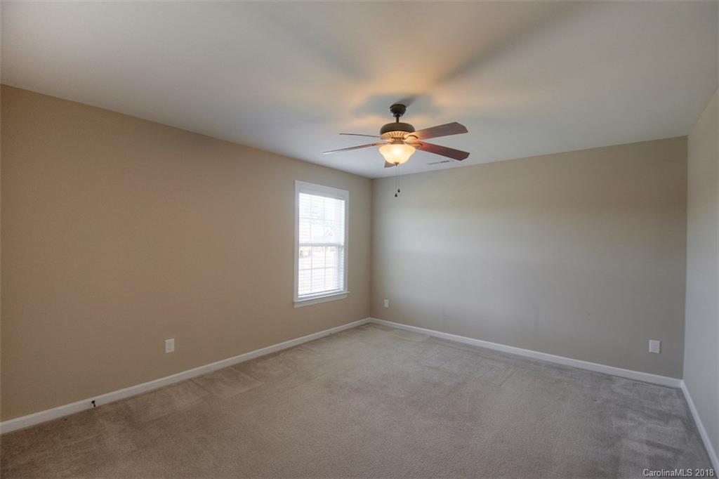 2001 Spring Rose Lane Wesley Chapel, NC 28104 - Photo 36 of 36 an empty room with windows and chandelier fan