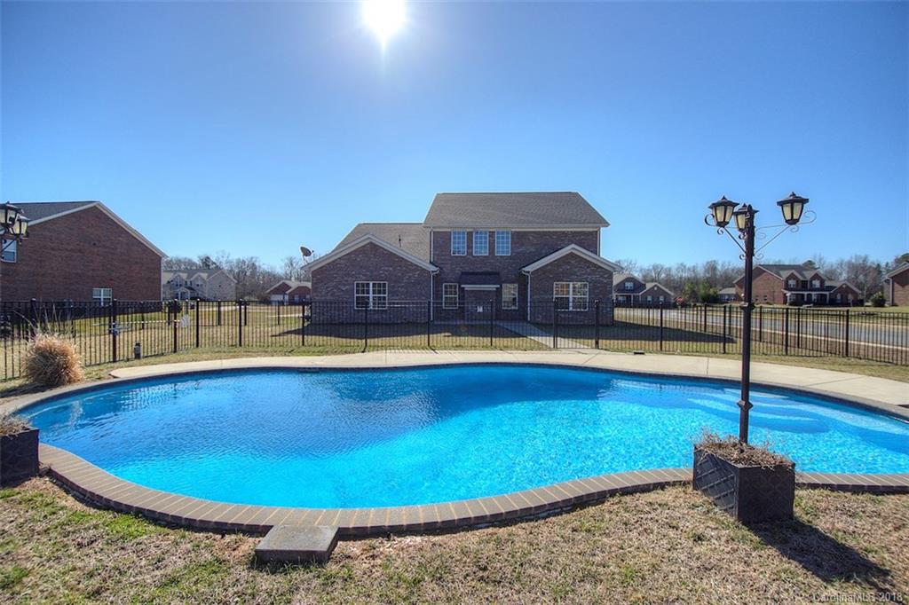 2001 Spring Rose Lane Wesley Chapel, NC 28104 - Photo 8 of 36 a view of a swimming pool with a yard