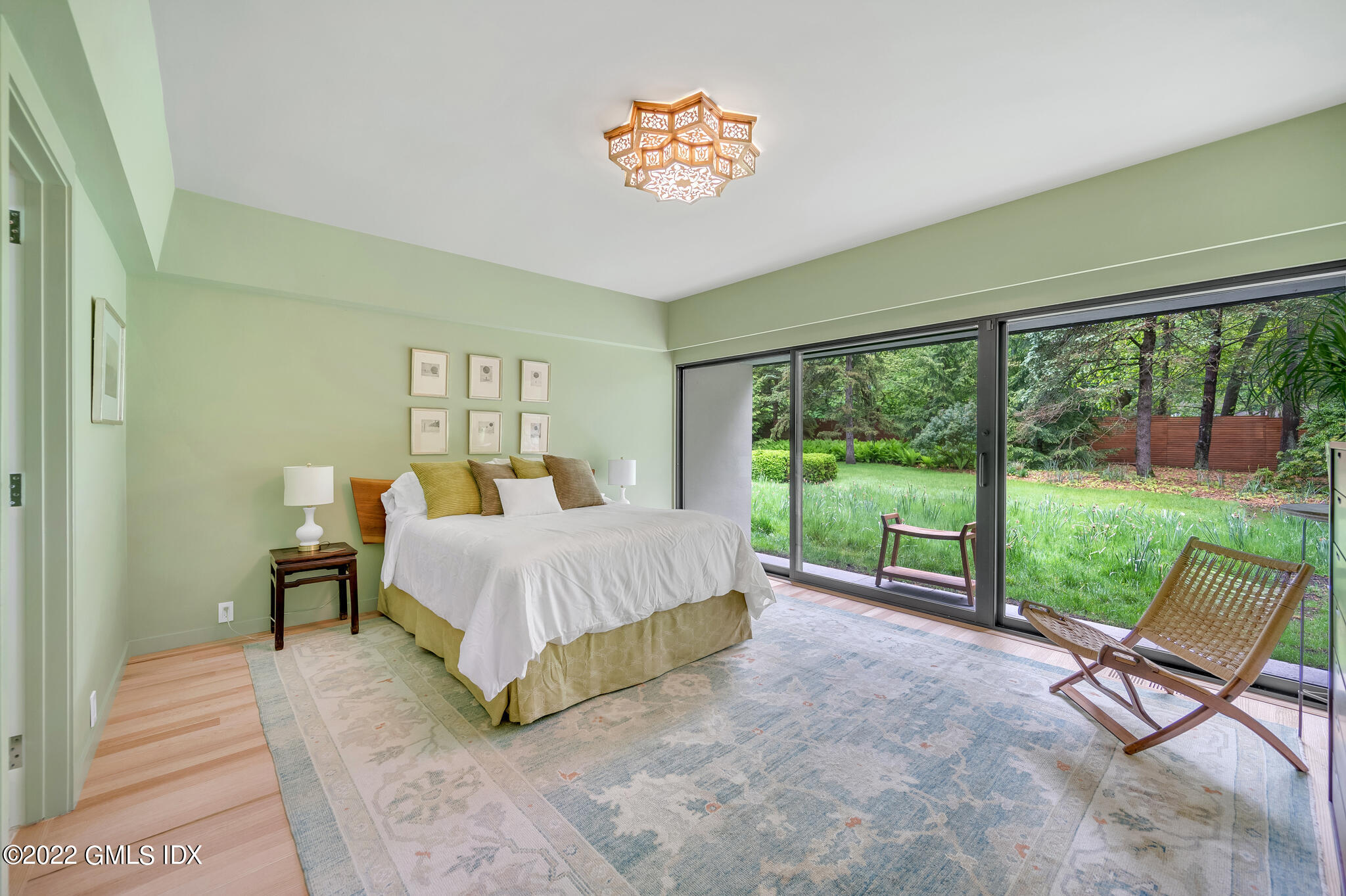 3 North Stanwich Road Greenwich, CT 06831 - Photo 25 of 35 a bed sitting in a bedroom next to a large window
