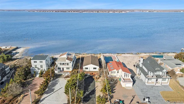an aerial view of a house with a ocean view