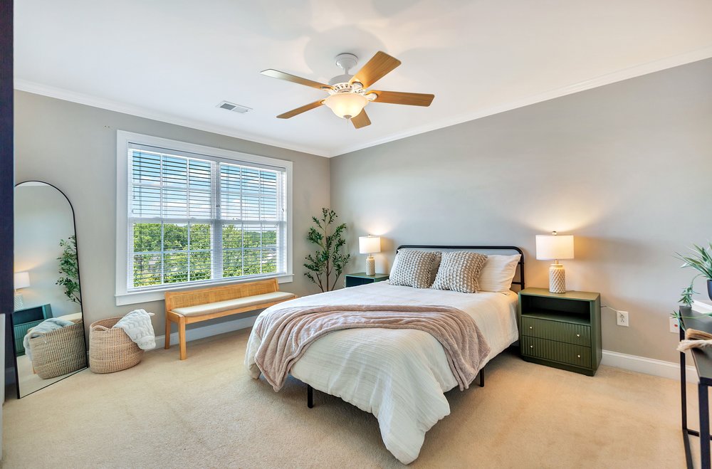 15 Fawn Hill Drive Anderson, SC 29621 - Photo 27 of 38 This airy bedroom offers a serene retreat with expansive views and comfort.
