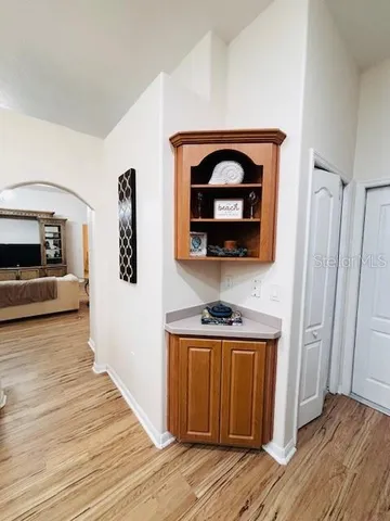 a view of a livingroom with wooden floor and furniture