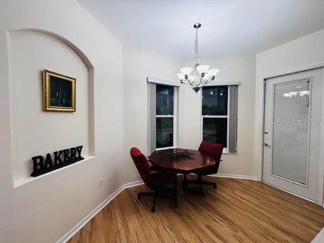 a view of a dining room with furniture and wooden floor