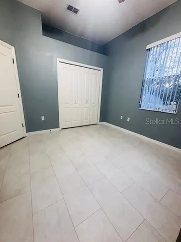 an empty room with furniture and a dresser