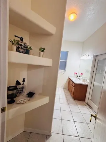 a bathroom with a granite countertop shower a toilet and sink