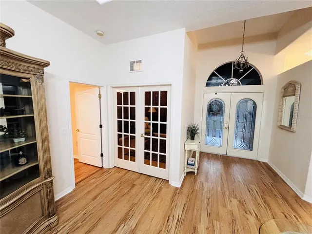 a view of empty room with wooden floor and cabinets