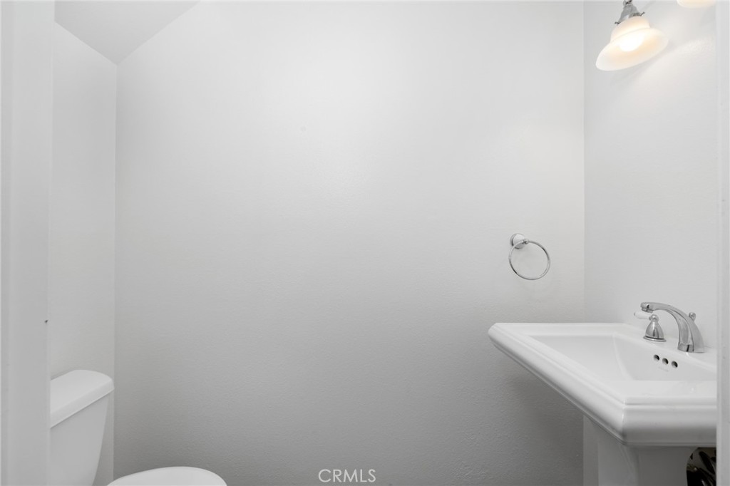 856 West Olive Avenue, Unit C Monrovia, CA 91016 - Photo 12 of 37 a bathroom with a sink a toilet and a mirror