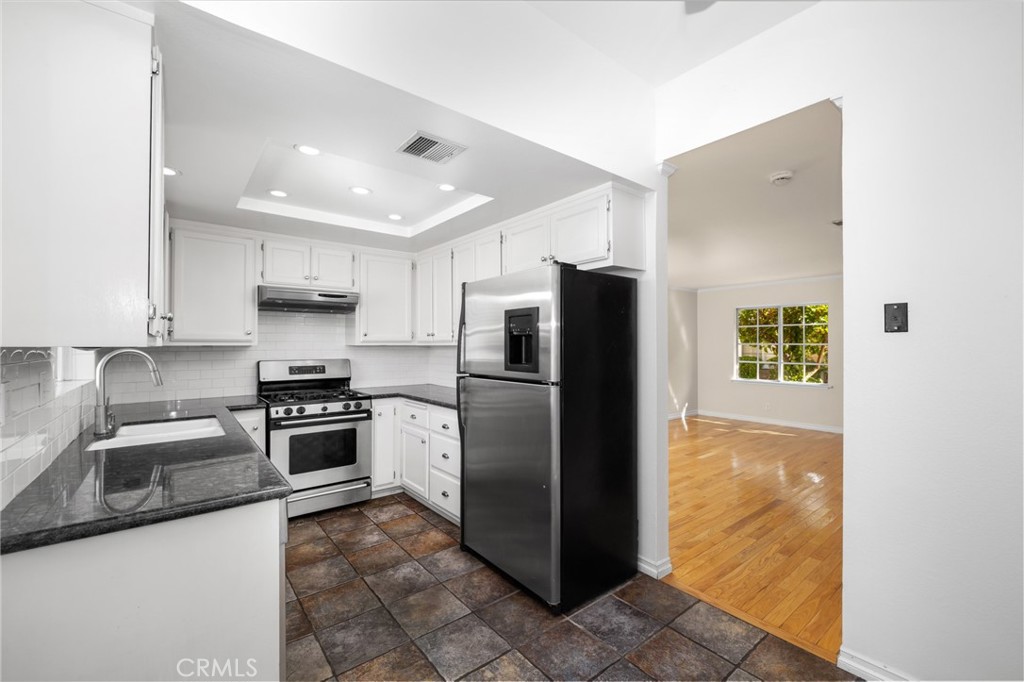856 West Olive Avenue, Unit C Monrovia, CA 91016 - Photo 16 of 37 a kitchen with stainless steel appliances granite countertop a refrigerator a stove and a sink