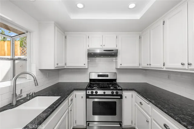 a kitchen with a sink and a refrigerator