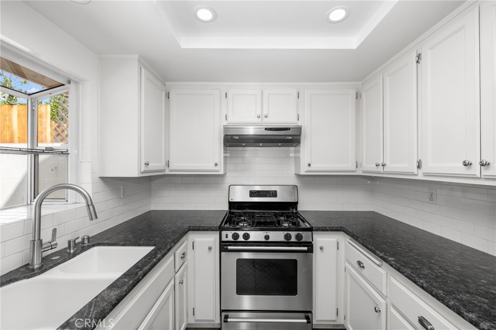 856 West Olive Avenue, Unit C Monrovia, CA 91016 - Photo 18 of 37 a kitchen with granite countertop white cabinets and stainless steel appliances