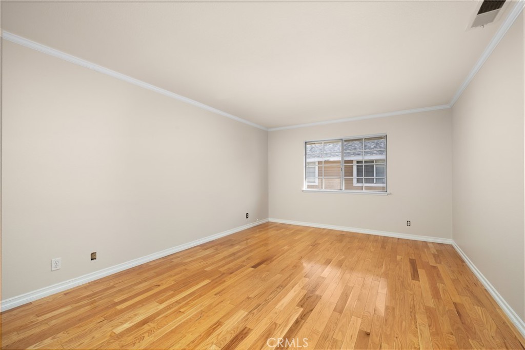 856 West Olive Avenue, Unit C Monrovia, CA 91016 - Photo 20 of 37 an empty room with wooden floor and windows
