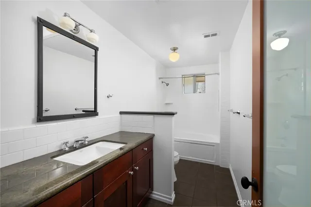 a bathroom with a toilet and a tub