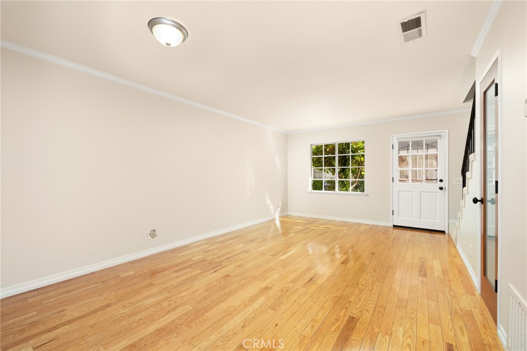 856 West Olive Avenue, Unit C Monrovia, CA 91016 - Photo 10 of 37 an empty room with wooden floor and windows