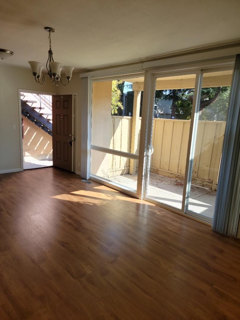 2006 Klamath Avenue, Unit 2 Santa Clara, CA 95051 - Photo 6 of 13 a view of an empty room with wooden floor and a window