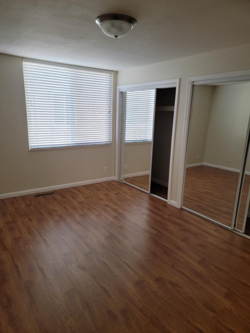 2006 Klamath Avenue, Unit 2 Santa Clara, CA 95051 - Photo 10 of 13 a view of an empty room with wooden floor and a window