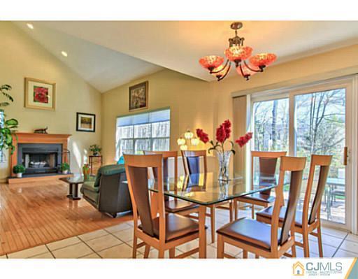 2 Stratton Road Old Bridge, NJ 07747 - Photo 11 of 24 a view of a dining room with furniture a chandelier and wooden floor