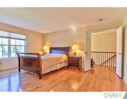 2 Stratton Road Old Bridge, NJ 07747 - Photo 17 of 24 a bedroom with a bed and wooden floor