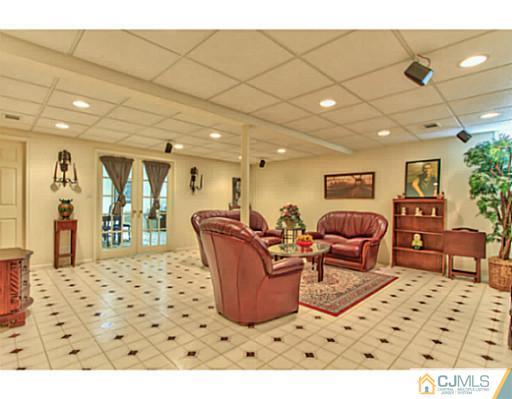 2 Stratton Road Old Bridge, NJ 07747 - Photo 19 of 24 a living room with furniture a flat screen tv and a table