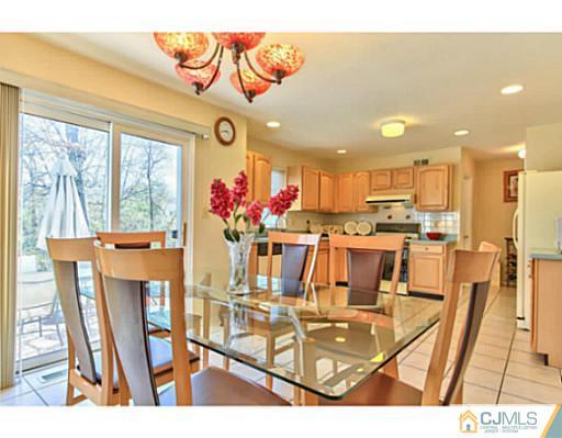 2 Stratton Road Old Bridge, NJ 07747 - Photo 8 of 24 a view of a dining hall with a dining table chairs and white walls