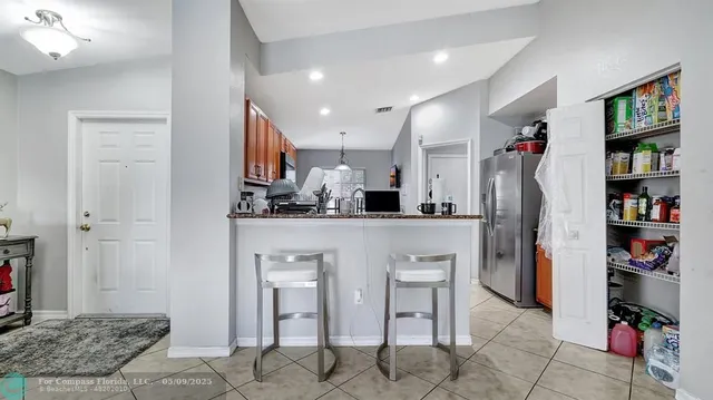 a kitchen with stainless steel appliances a refrigerator and window