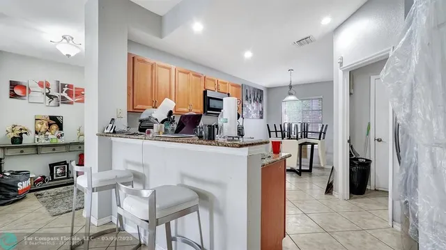 a kitchen with stainless steel appliances granite countertop a stove top oven a sink dishwasher and cabinets with wooden floor