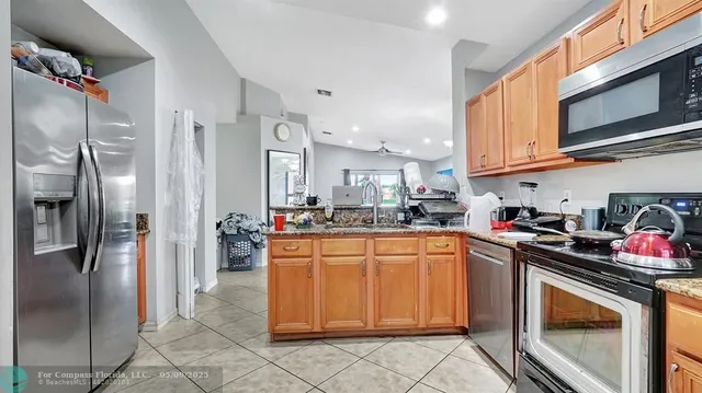 a view of a dining room with furniture and a flat screen tv