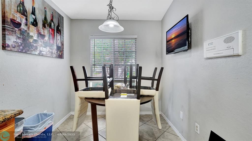 4558 Southwest 125th Lane Miramar, FL 33027 - Photo 17 of 47 a view of a dining room with furniture and a flat screen tv