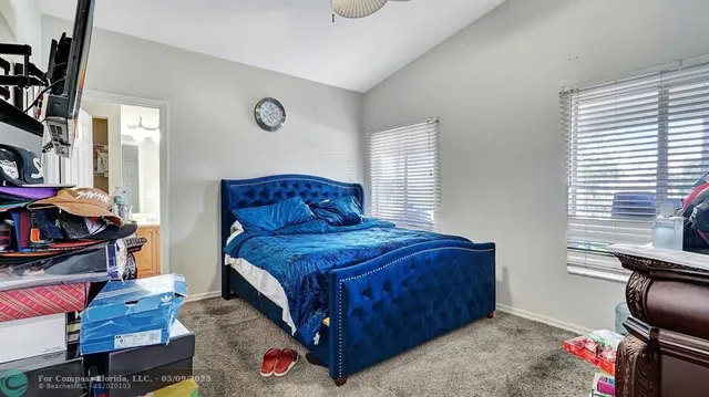 a bedroom with a bed and flat screen tv