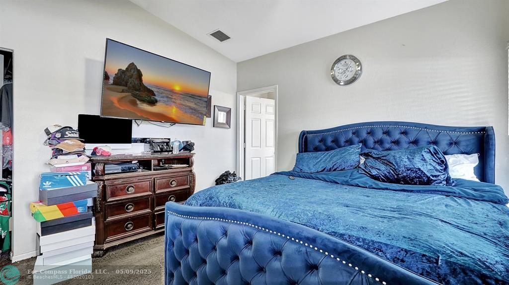 4558 Southwest 125th Lane Miramar, FL 33027 - Photo 25 of 47 a bedroom with a bed and a flat screen tv