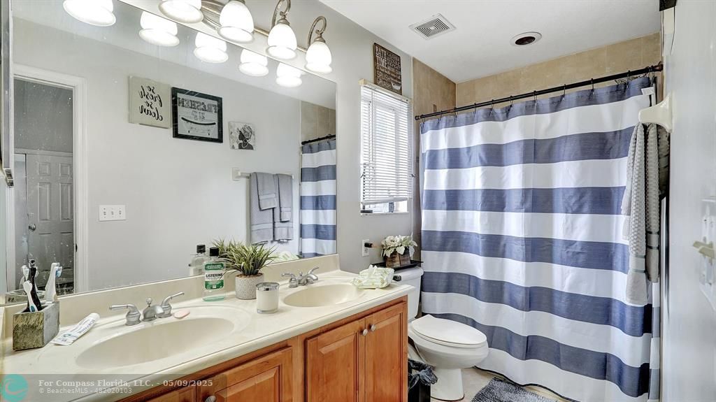 4558 Southwest 125th Lane Miramar, FL 33027 - Photo 26 of 47 a bathroom with a sink toilet and shower