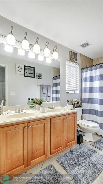 4558 Southwest 125th Lane Miramar, FL 33027 - Photo 27 of 47 a spacious bathroom with a sink a toilet and a bathtub