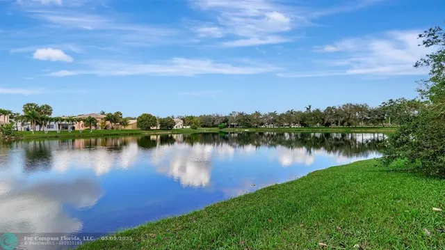 a view of a lake with houses in the background