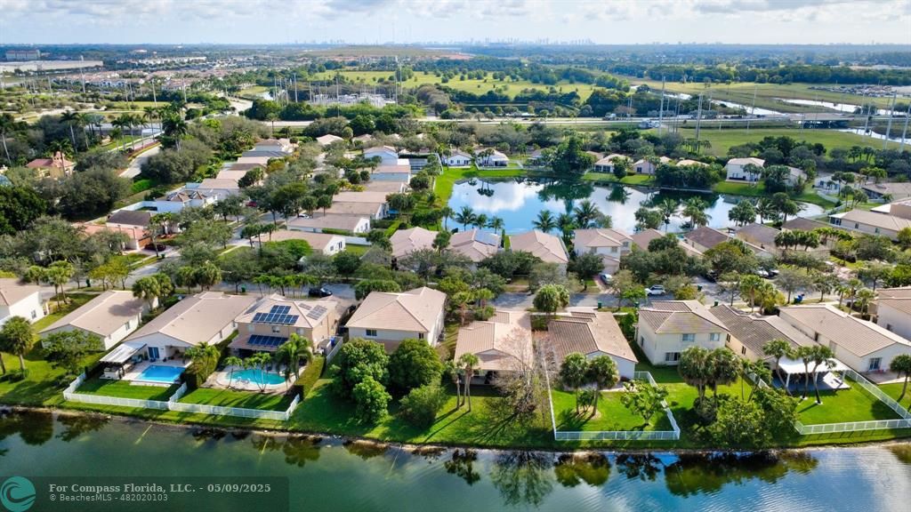 4558 Southwest 125th Lane Miramar, FL 33027 - Photo 45 of 47 an aerial view of residential houses with outdoor space and trees