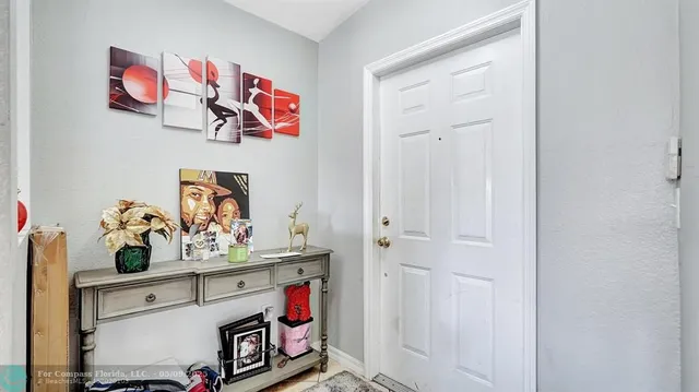 a living room with furniture a flat screen tv and a large window