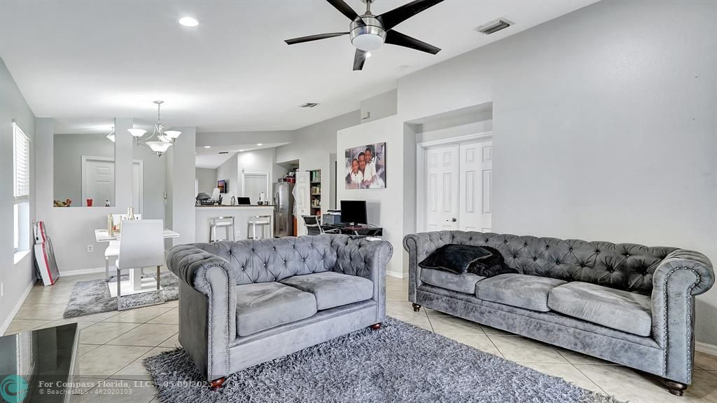 4558 Southwest 125th Lane Miramar, FL 33027 - Photo 8 of 47 a living room with furniture and a chandelier