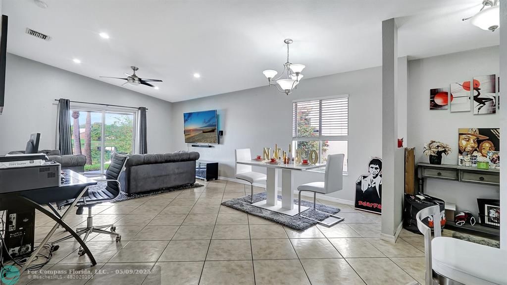 4558 Southwest 125th Lane Miramar, FL 33027 - Photo 10 of 47 a living room with furniture and a dining table with kitchen view