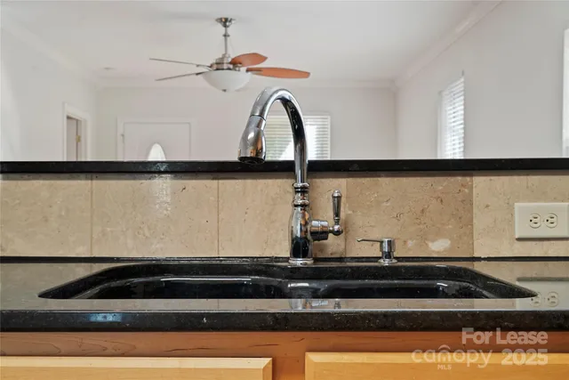 a close view of sink a faucet and a stove