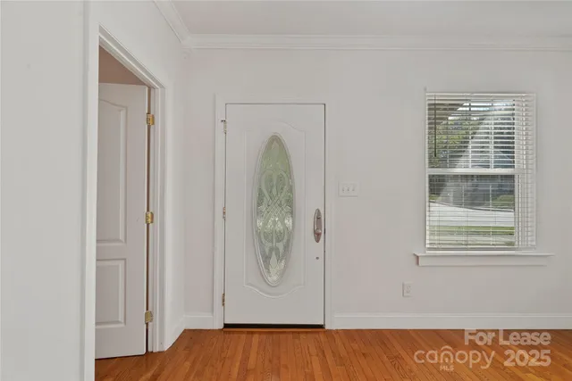 a view of front door with wooden floor