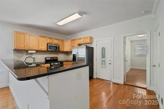 a kitchen with stainless steel appliances granite countertop a refrigerator stove top oven a sink and dishwasher