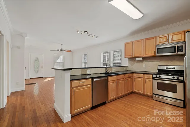 a kitchen with stainless steel appliances granite countertop a stove and a sink