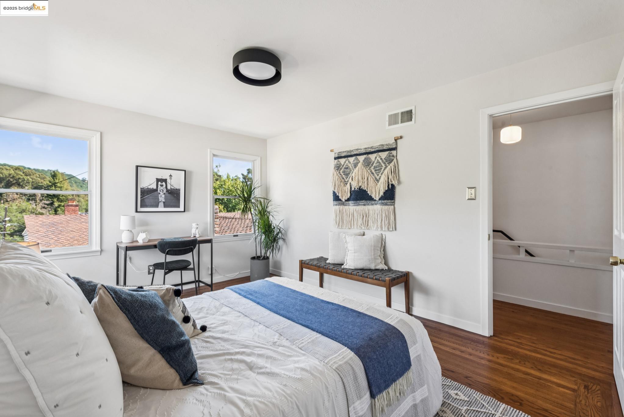 4479 Elinora Avenue Oakland, CA 94619 - Photo 28 of 47 Bedroom featuring wood finished floors, multiple windows, and an office area