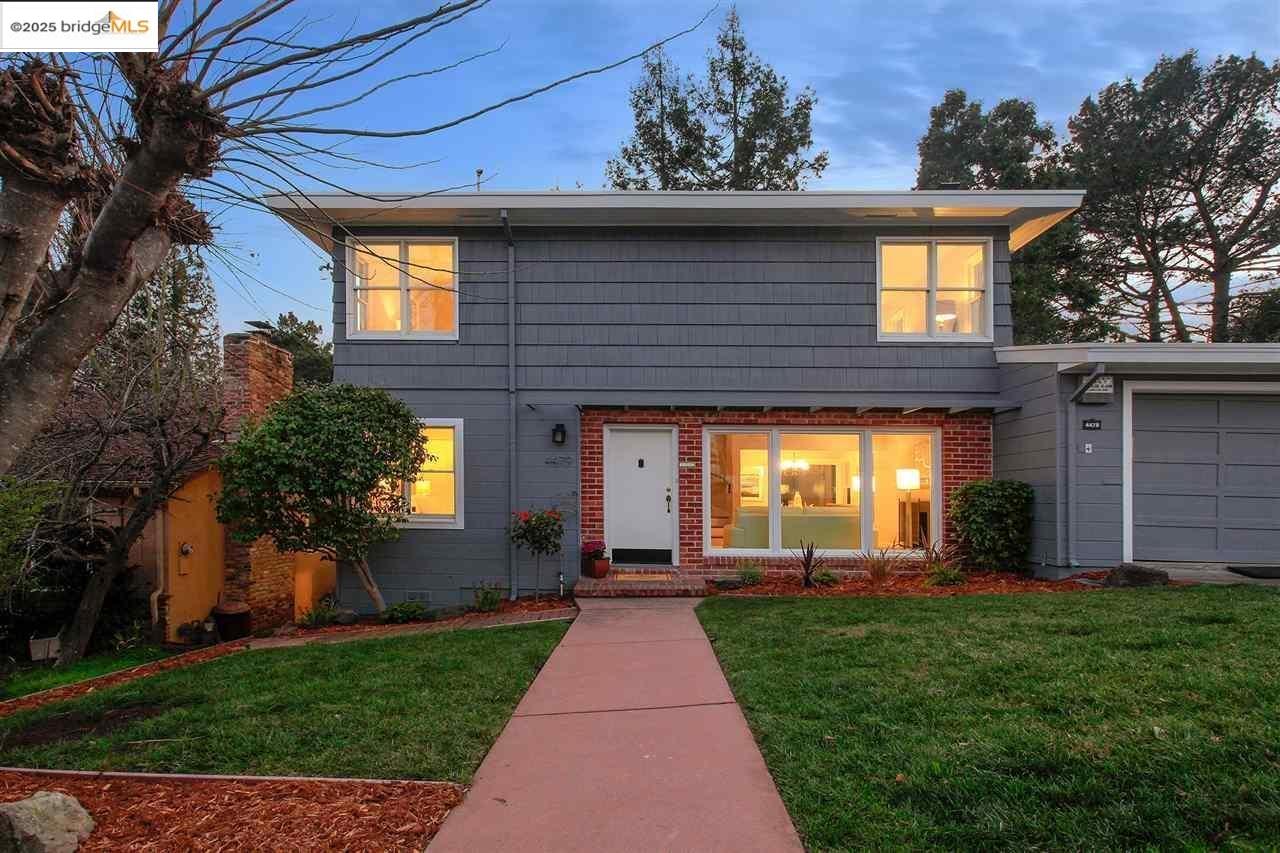 4479 Elinora Avenue Oakland, CA 94619 - Photo 45 of 47 View of front of house with an attached garage, brick siding, and a front yard