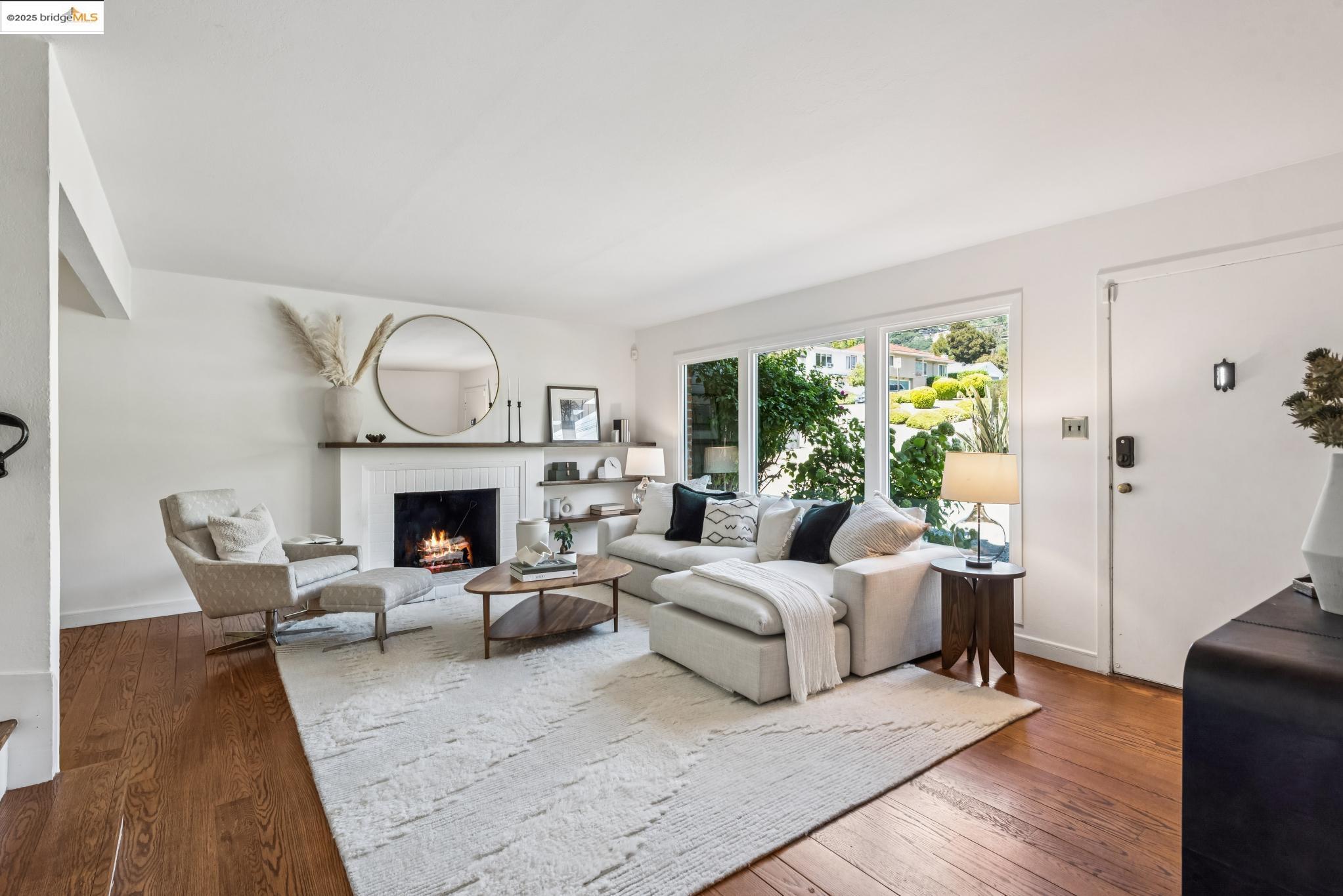 4479 Elinora Avenue Oakland, CA 94619 - Photo 7 of 47 Living area featuring a brick fireplace and dark wood-style flooring