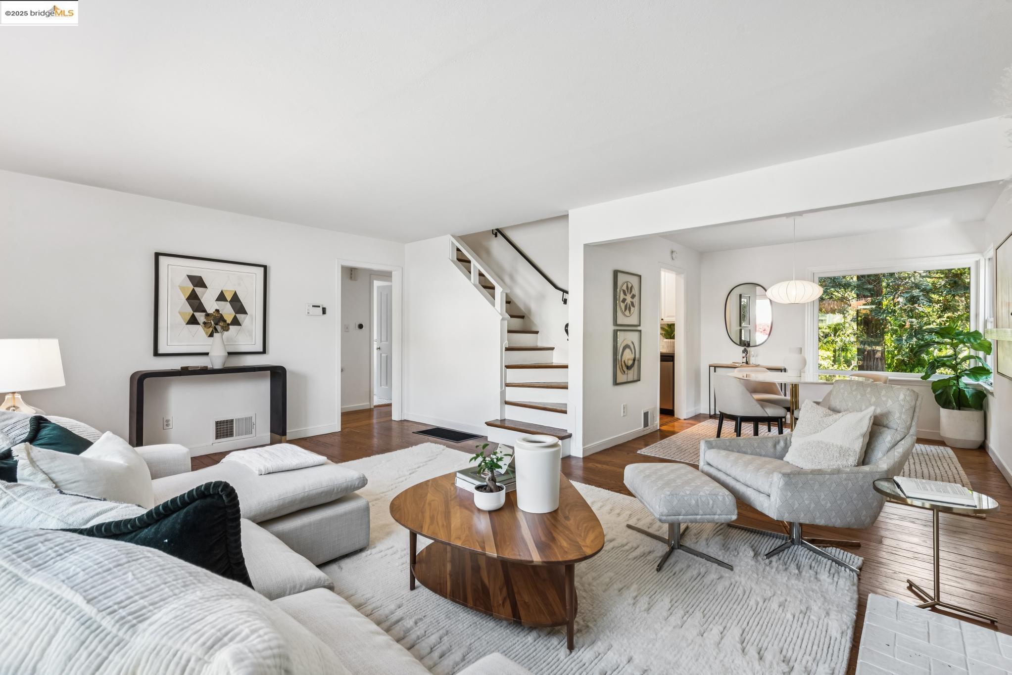 4479 Elinora Avenue Oakland, CA 94619 - Photo 9 of 47 Living area featuring wood finished floors and stairway