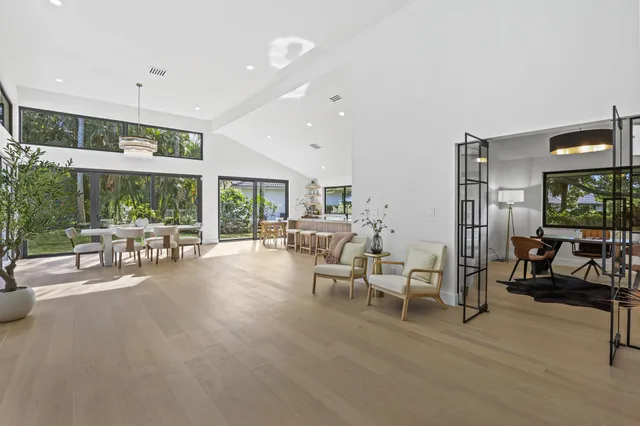 a dining room with furniture and a floor to ceiling window