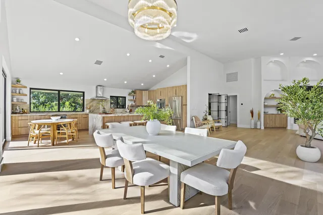 a large kitchen with a table and chairs
