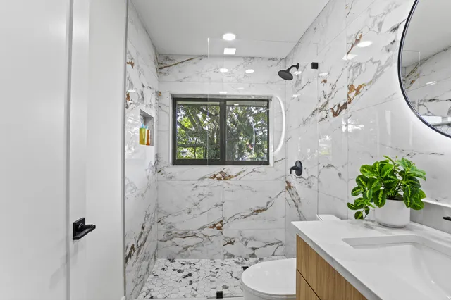 a spacious bedroom with a bed and a large window